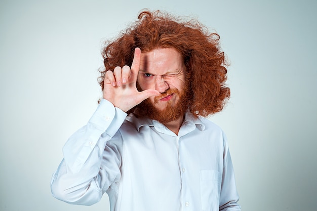 Gratis foto de jonge man die l-teken doet