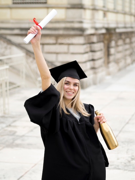 De jonge vrouw die van Smiley graduatietoga draagt