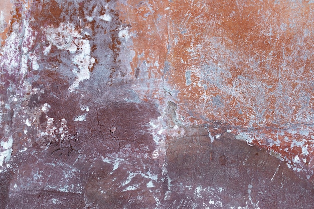 De oude beschadigde gemengde kleur van de muurtextuur