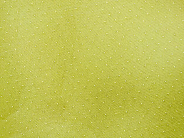 De polka stippelde groene textielachtergrond