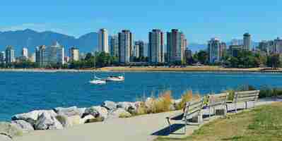 Gratis foto de stadshorizon van vancouver aan de waterkant met bank in park