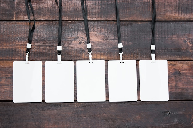 Gratis foto de vijf kaart badges met touwen op houten tafel