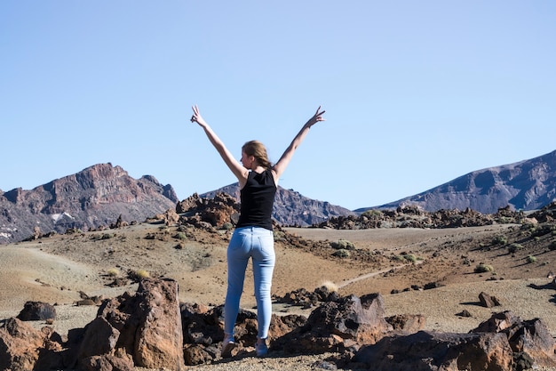 Gratis foto de vrouw die vredesteken tonen met dient lucht in