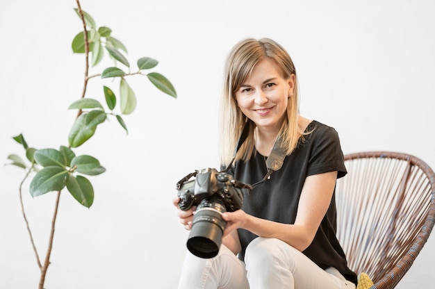 De vrouwenzitting van Smiley op een stoel met een camerafoto