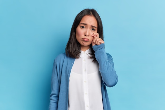 Depressieve brunette vrouw veegt tranen af, kreten van wanhoop is ontevreden verdrietig gezicht uitdrukking draagt nette kleren staat voor onoplosbare problemen in het leven