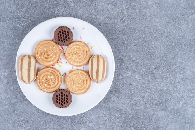 Diverse zoete koekjes op witte plaat