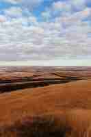 Gratis foto droog woestijngebied met een weg in het midden en verbazingwekkende wolken in de lucht