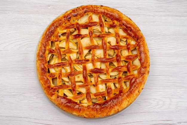 Een bovenaanzicht fruitcake rond heerlijk op het lichtbureau cake koekje fruit