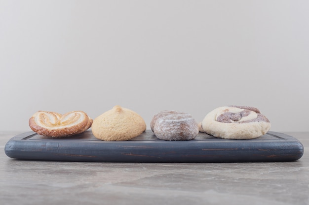 Een bundel van verschillende koekjes op een bord op marmer