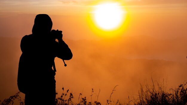 Een fotograaf fotografeert de dageraad van de zon op de vulkaan Batur. Bali, Indonesië