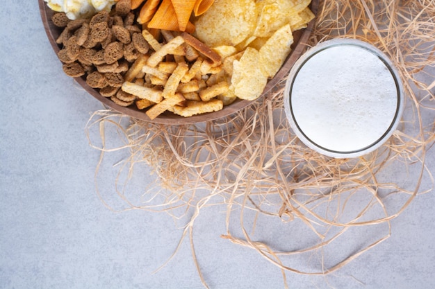 Gratis foto een glas bier met heerlijke soepstengels en chips