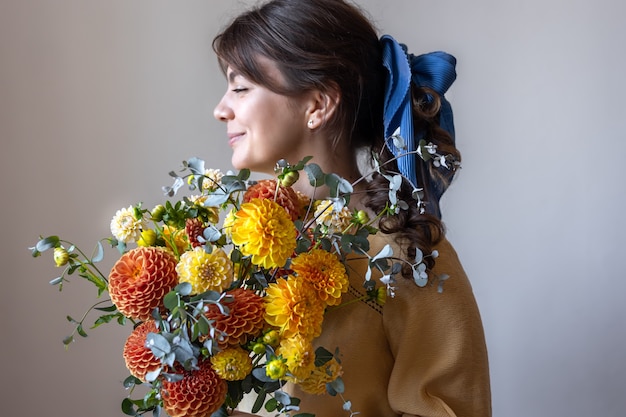 Een jonge vrouw houdt een boeket chrysantenbloemen vast