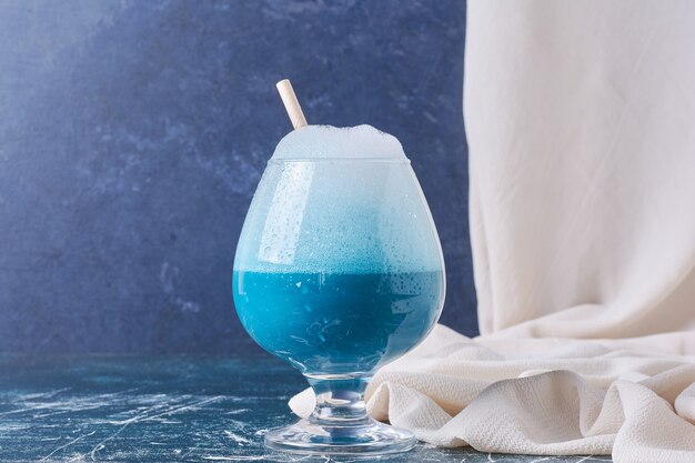 Een kopje drank op blauw.