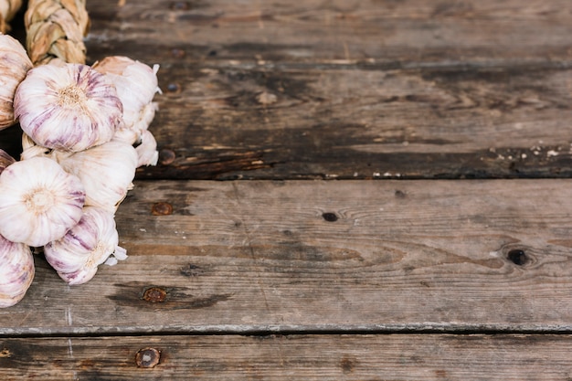 Een organische enkele knoflook bollen vlecht op houten achtergrond