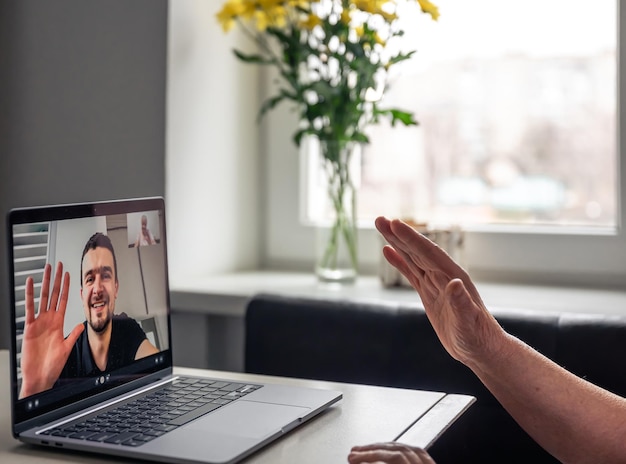 Gratis foto een oude vrouw communiceert met haar zoon via een videoverbinding via een laptop