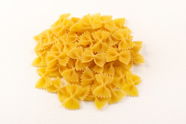 Een ruwe gele de deegwareninzameling van vooraanzicht Italiaanse droge deegwaren voerde op de witte achtergrond voedselmaaltijd Italiaans