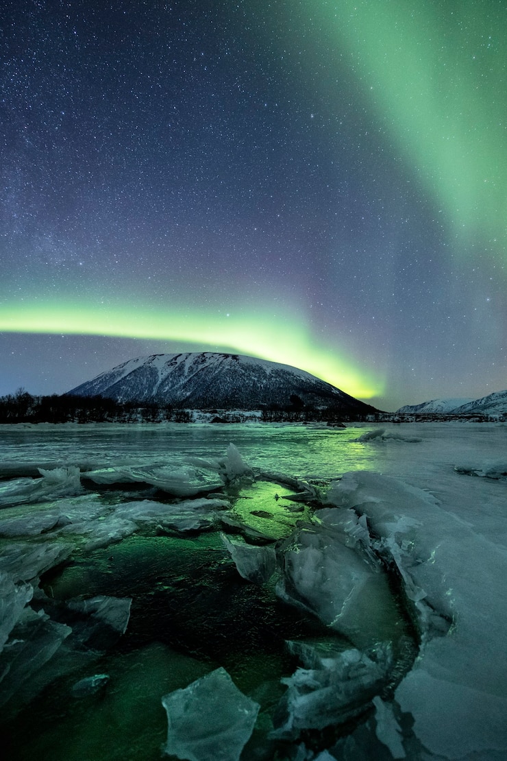 Gratis Foto een verticale opname van besneeuwde bergen onder poollicht
