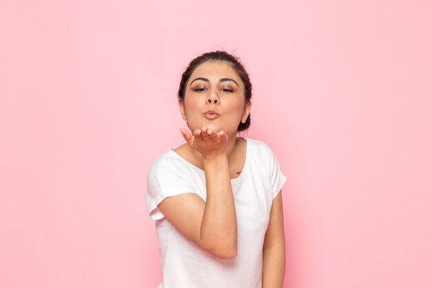 Een vooraanzicht jonge vrouw in wit t-shirt luchtkussen dame emotie gebaar verzenden