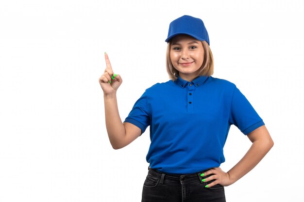 Een vooraanzicht jonge vrouwelijke koerier in blauw uniform poseren met een glimlach op haar gezicht