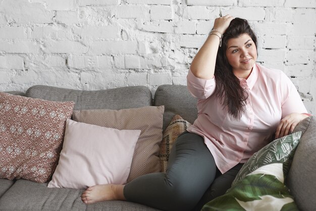 Een vrouw met een mooi lichaam poseren op de bank