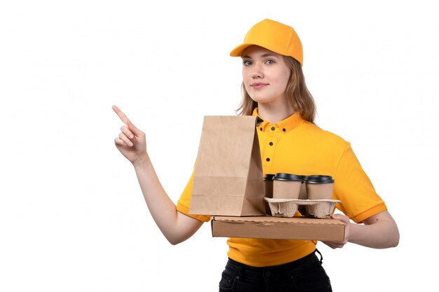 Een vrouwelijke werknemer van de vooraanzicht jonge vrouwelijke koerier van van de de leveringsdienst van de voedsellevering de pizzadoos en voedselpakketten op wit