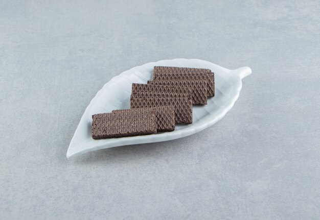 Een witte kom vol chocoladewafels.