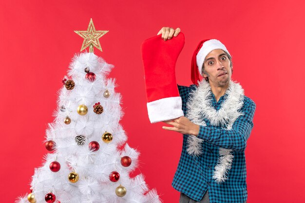 Er staat een man naast de kerstboom