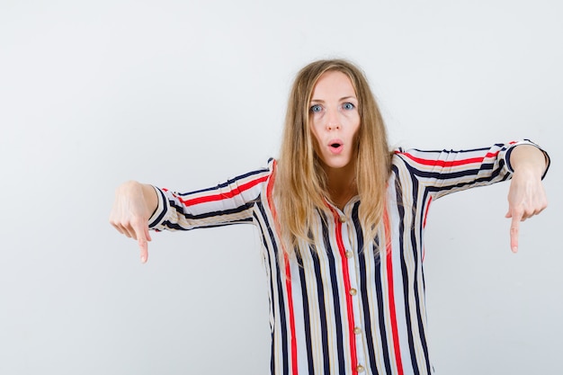 Gratis foto expressieve jonge vrouw poseren in de studio