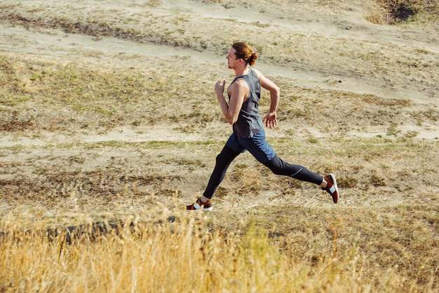 Fit gespierde mannelijke atleet training trail lopen voor marathon lopen