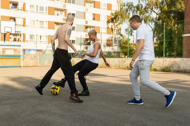 Full shot vrienden die met de bal spelen in de buitenwijken