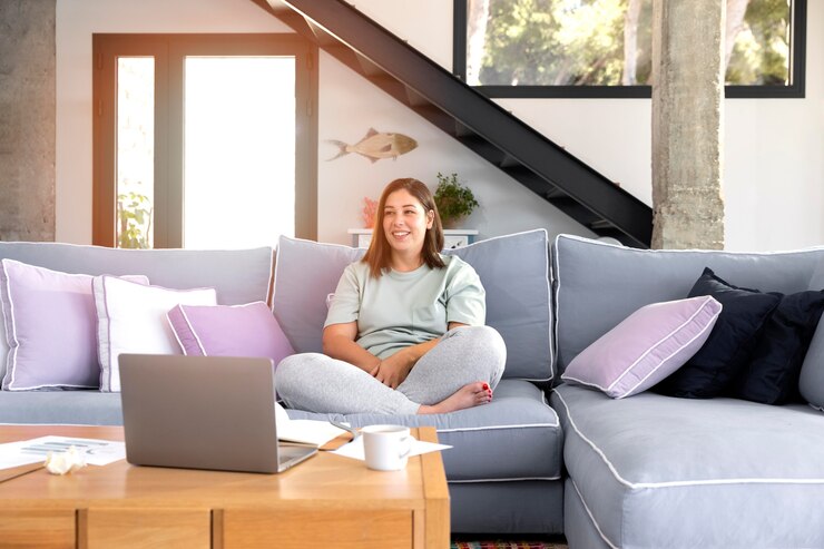 Gratis Foto full shot vrouw zittend op de bank