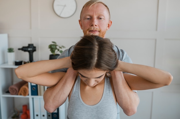 Fysiotherapeut tijdens een therapiesessie met vrouwelijke patiënt