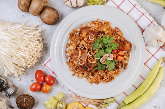 Gebakken kippenbout met tomaat, chili, gebakken ui, sla, maïs en naaldchampignon.