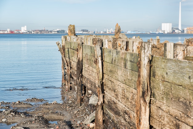 Gebroken pier op de zee onder de heldere hemel