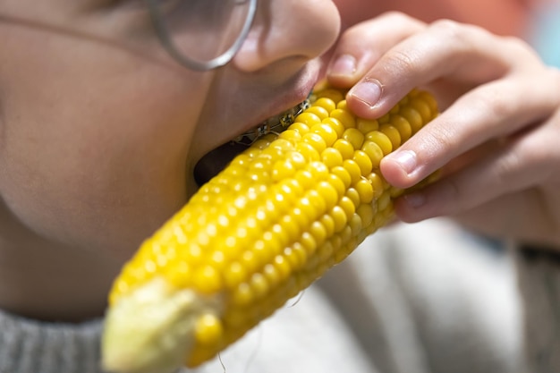 Gratis foto gedetailleerde opname van een meisje dat maïs eet