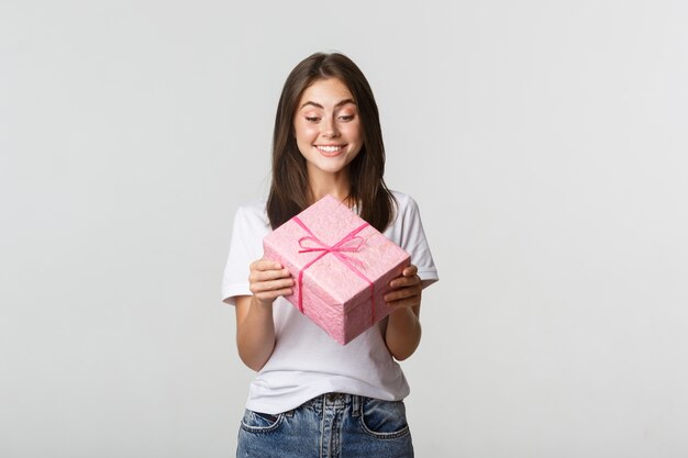 Gelukkig schattig jong feestvarken, glimlachend en kijken naar b-dag cadeau.