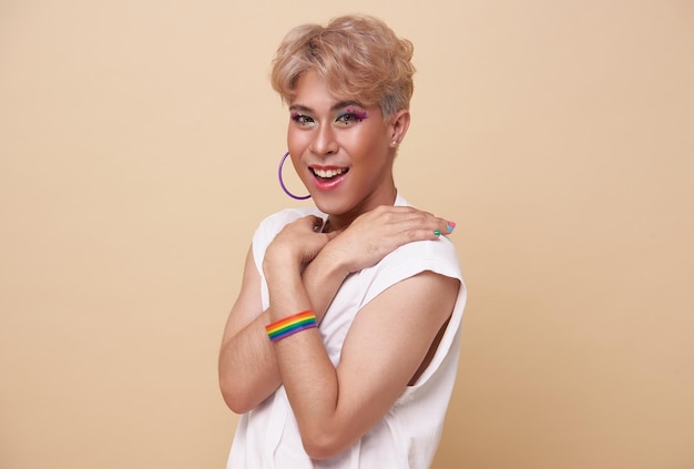 Gelukkige tiener aziatische transgender LGBT geïsoleerd over naakte kleurenachtergrond