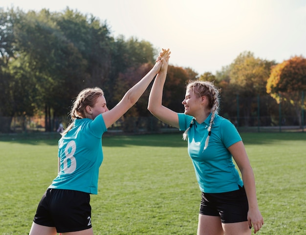 Gratis foto gelukkige voetballers high five