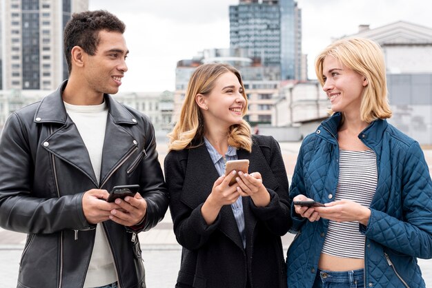 Gelukkige vrienden met mobiele telefoons