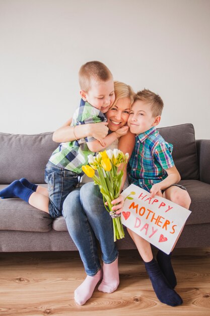 Gelukkige vrouw die met haar kinderen lacht en moederdag viert