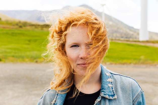 Gember-haired jonge vrouw in de natuur