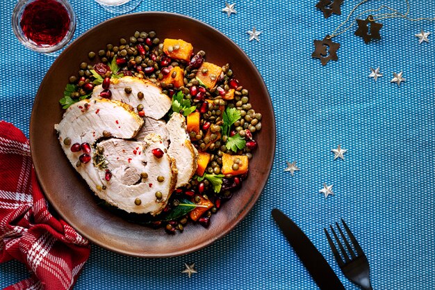 Geroosterde kerstham met granaatappel en linzen foodfotografie