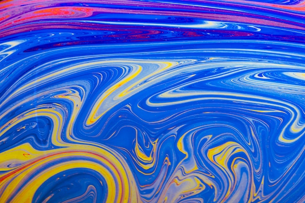 Gratis foto glanzende golvende blauwe gele en roze abstracte achtergrond