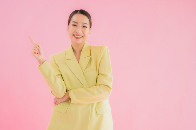 Glimlach van de portret de mooie jonge Aziatische bedrijfsvrouw in actie op roze kleur