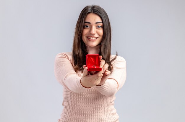 Glimlachend jong meisje op Valentijnsdag stak trouwring op camera geïsoleerd op een witte achtergrond