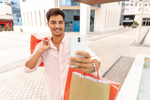 Gratis foto glimlachende jonge man selfie te nemen