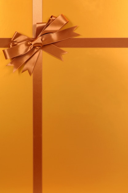 Gratis foto gouden kerst cadeau achtergrond met strik