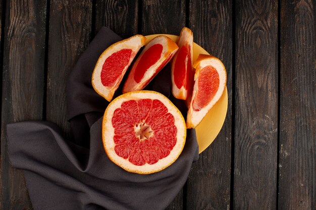 Grapefruit vers gesneden sappige binnenkant gele plaat en op de houten bruine rustiek