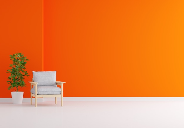 Grijze fauteuil in oranje woonkamer met kopie ruimte