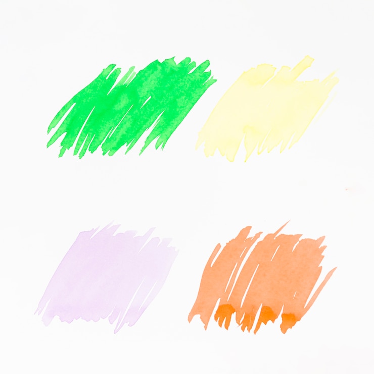 Gratis Foto groen; geel; roze en oranje penseelstreek op witte achtergrond